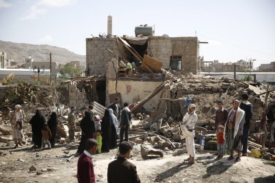 People gather at the site of a house destroyed by a Saudi-led airstrike in Sanaa Yemen Thursday Feb. 25 2016