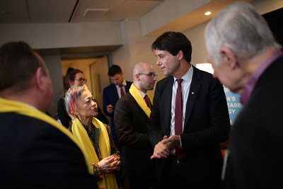 Ontario Health Minister Eric Hoskins speaking with Durhane Wong-Rieger President and CEO of the Canadian Organization for Rare Disorders at Queen's Park on International Rare Disease Day