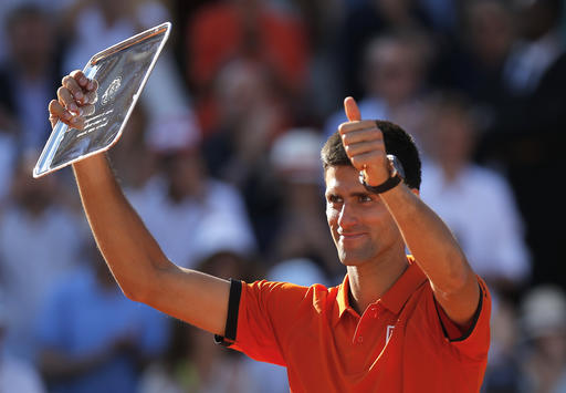 Serbia's Novak Djokovic shows his second place plate after losing to Switzerland's Stan Wawrinka in the final match of the French Open tennis tournament at the Roland Garros stadi