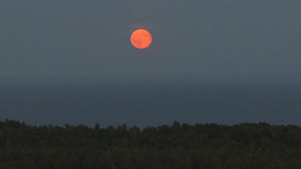 A full moon rises over Lake Superior during summer in Duluth Minn. Bob King