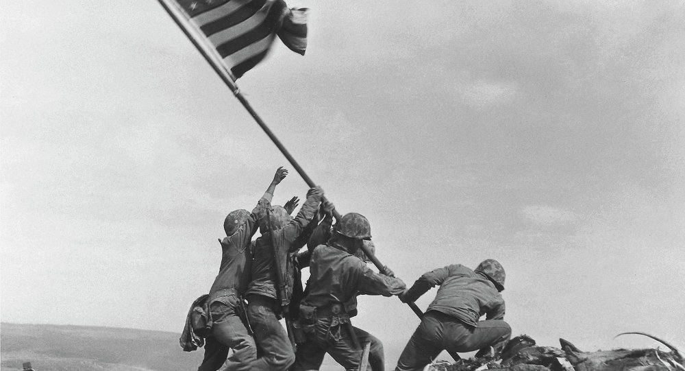 US Marines of the 28th Regiment 5th Division raise the American flag atop Mt. Suribachi Iwo Jima