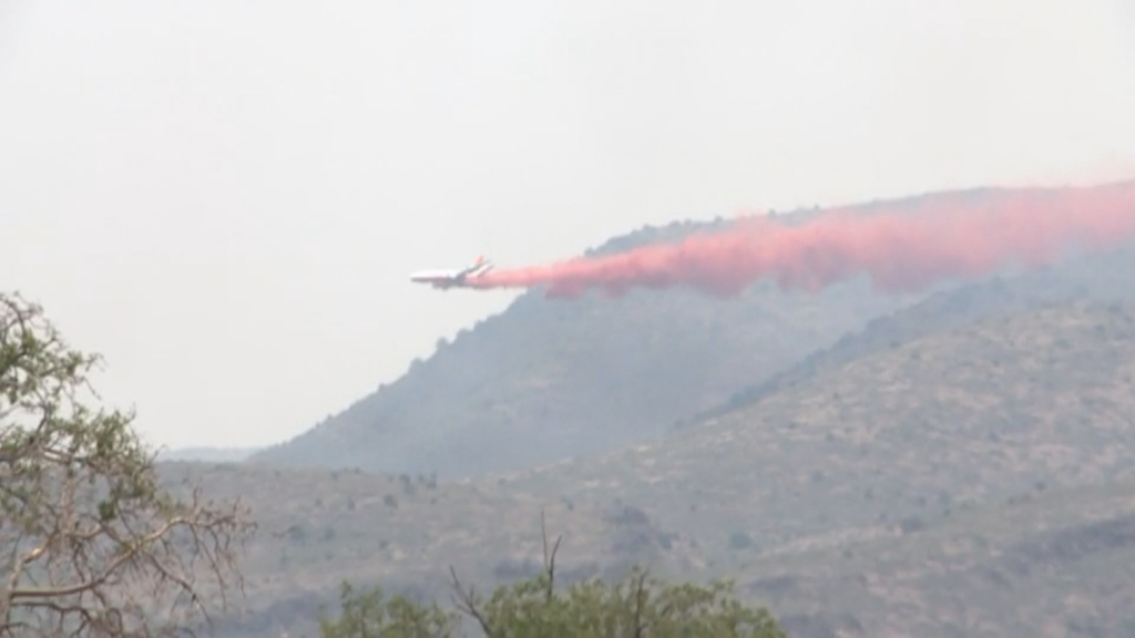 An air drop of fire retardant helps stop the spread of the Tenderfoot Fire near Yarnell Ariz