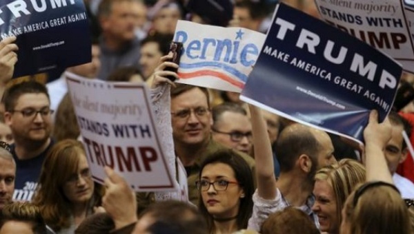 A protester looks on while surrounded by supporters of Donald Trump as Trump speaks at a campaign rally in Cleveland Ohio