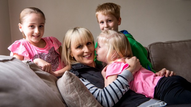 Kylie Gellie who has had a mastectomy and oophorectomy to avoid breast and ovarian cancer with her children Jasmine