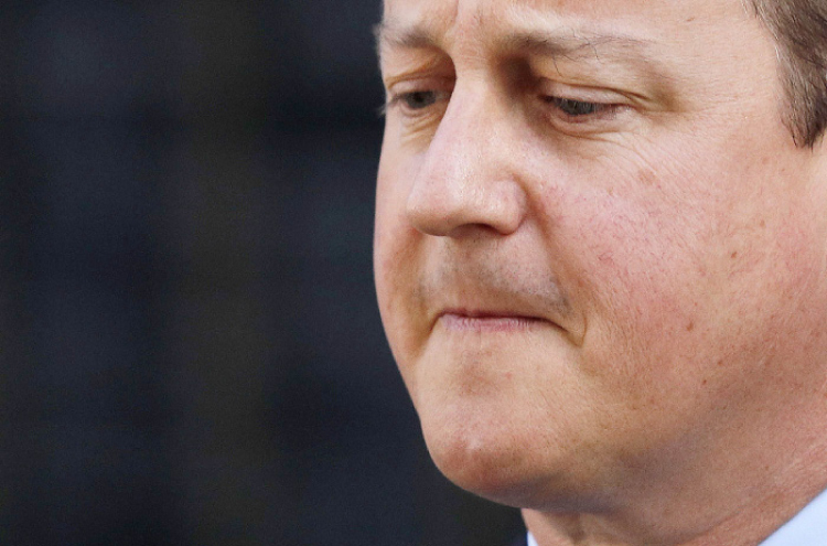 British Prime Minister David Cameron speaks to the press in front of 10 Downing Street in central London Friday. — AFP