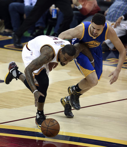 Cleveland Cavaliers guard J.R. Smith and Golden State Warriors guard Klay Thompson race for the ball during the first half of Game 3 of the NBA Finals in Cleveland on Wednesday. AP