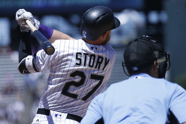 Colorado Rockies&#39 Trevor Story follows the flight of his out on a pitch from New York Yankees starting pitcher Ivan Nova in the first inning of a baseball game Wednesday