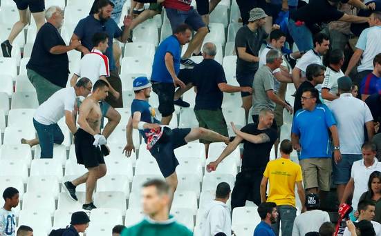 England fans try to escape trouble in the stadium at full time