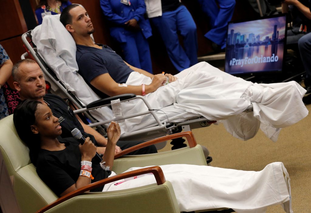 Gunshot survivor Patience Carter recounts her story as fellow survivor Angel Santiago and Dr. Brian Vickaryous look on during a news conference at Florida Hospital Orlando on the shooting at the Pulse gay nightclub in Orlando Florida