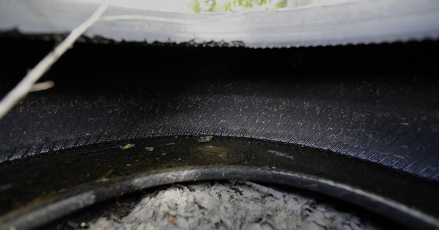 2016 water collects inside a tire which is one of several tires left as trash in a neighborhood near downtown Houston. Trash