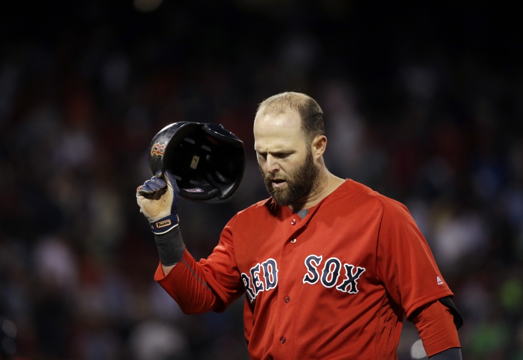 Boston Red Sox's Dustin Pedroia takes his helmet off after grounding out to end a baseball game against the Seattle Mariners at Fenway Park on Friday