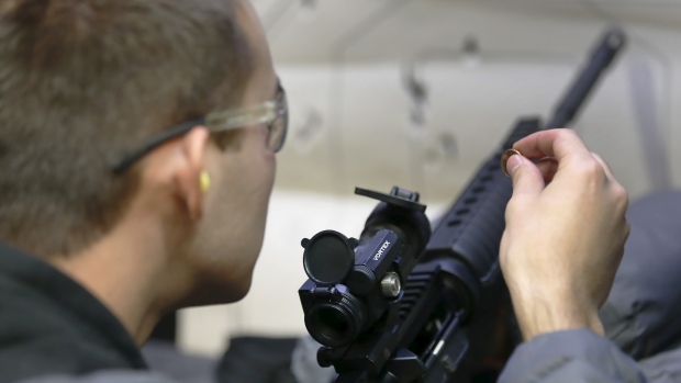 A gun enthusiast adjusts the sights of an AR-15 rifle at a gun range in Utah last year. The maker of the weapon faces a key court test on Monday from the families of victims who were killed by someone using that gun