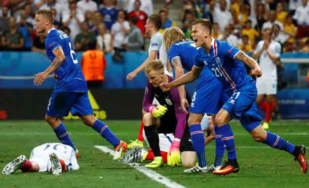 Football Soccer- England v Iceland- EURO 2016- Round of 16- Stade de Nice Nice France- 27/6/16 Iceland players celebrate as England's Joe Hart looks dejected after the game REUTERS  Kai Pfaffenbach Livepic