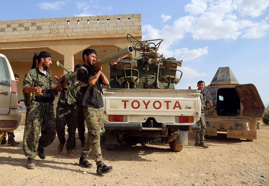 Kurdish fighters prepare a rocket launcher as they advance into the Islamic State bastion of Manbij