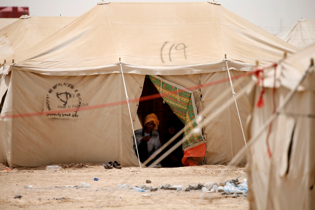 Displaced Iraqi people who fled from Falluja because of Islamic State violence sit inside a tent at a refugee camp in Ameriyat Falluja south of Falluja Iraq June 8 2016 REUTERS Thaier Al Sudani