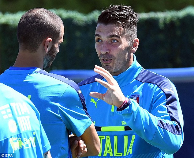 Italy goalkeeper Gianluigi Buffon speaks to team-mate Leonardo Bonucci during their training session