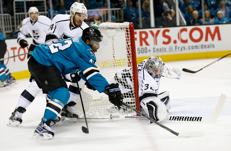 San Jose Sharks Joel Ward fights for the puck against the Los Angeles Kings'Jonathan Quick in the first period of Game 3 of the NHL Western Conference quarterfinals Monday