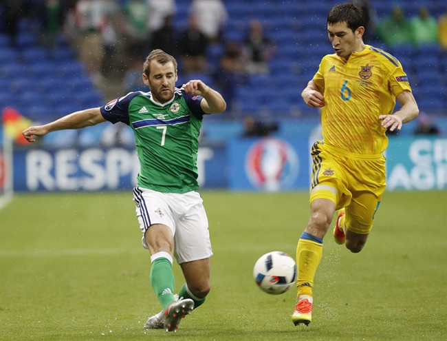 Northern Ireland's Niall Mcginn left kicks the ball past Ukraine's Taras Stepanenko during the Euro 2016 Group C soccer match between Ukraine and Northern Ireland at the Grand Stade in Decines-�Charpieu near Lyon France Thursday