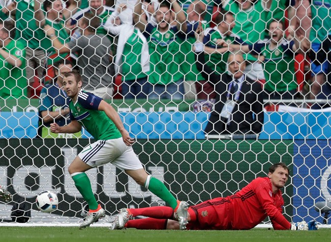 Northern Ireland's Niall Mcginn left celebrates after scoring his side’s second goal past Ukraine goalkeeper Andriy Pyatov right during the Euro 2016 Group C soccer match between Ukraine and Northern Ireland at the Grand Stade in Decines-�Char