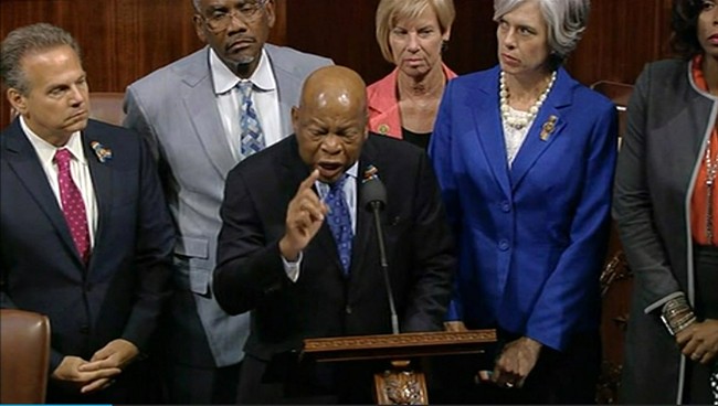 In this frame grab taken from AP video Georgia Rep. John Lewis leads more than 200 Democrats in demanding a vote on measures to expand background checks and block gun purchases by some suspected terrorists in the aftermath of last week's massacre in O