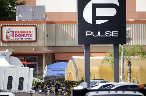 Members of the FBI Evidence Response Team gather outside of the Pulse Orlando nightclub Monday