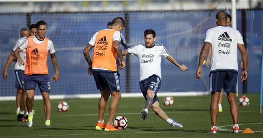 Argentina's Lionel Messi center works against Victor Cuesta during a training session ahead of the team's Copa America soccer final against Chile Friday