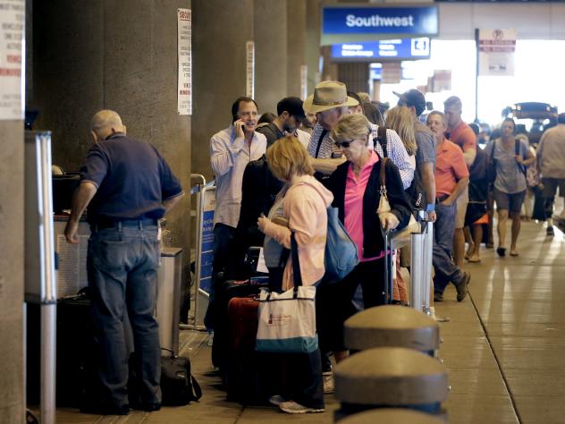 Passengers line up to check in before their flights in May at Sky Harbor International Airport in Phoenix. Two new automated security lanes at the Atlanta Airport are aimed at reducing long wait times