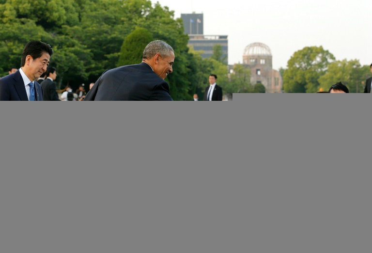 POOL  AFP  Kimimasa MayamaUS President Barack Obama greets a school student as Japanese Prime Minister Shinzo Abe watches after laying wreaths for victims of the atomic bombing in 1945 at Hiroshima Peace Memorial Park