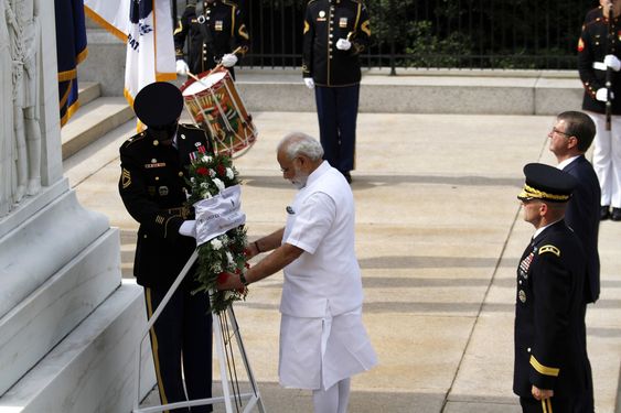 Narendra Modi center with Secretary of Defense Ash Carter right and Maj. Gen. Bradley Becker lays a wreath at the Tomb of the Unknowns at Arlington National Cemetery in Arlington Va. Monday