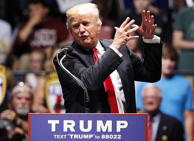 Steve Helber- Republican presidential candidate Donald Trump gestures during a rally in Richmond Va. Friday