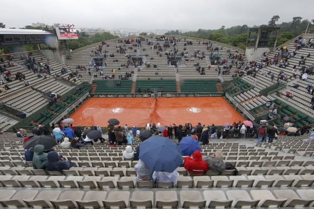 Play was suspended by rain at the French Open on Tuesday with world number one Novak Djokovic a set down against Roberto Bautista Agut