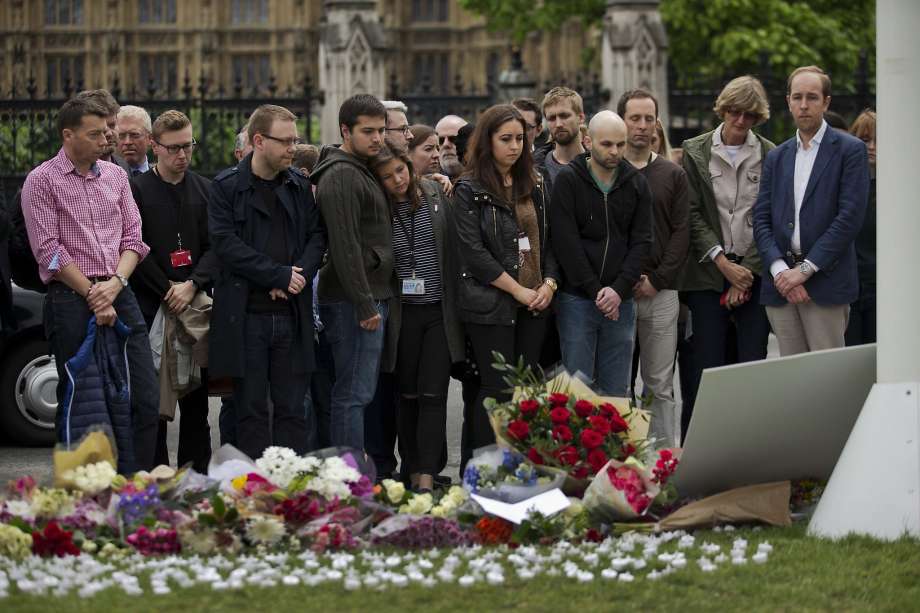 Labor Party members stand after placing floral tributes for their colleague Jo Cox the 41-year-old Member of Parliament shot to death Thursday