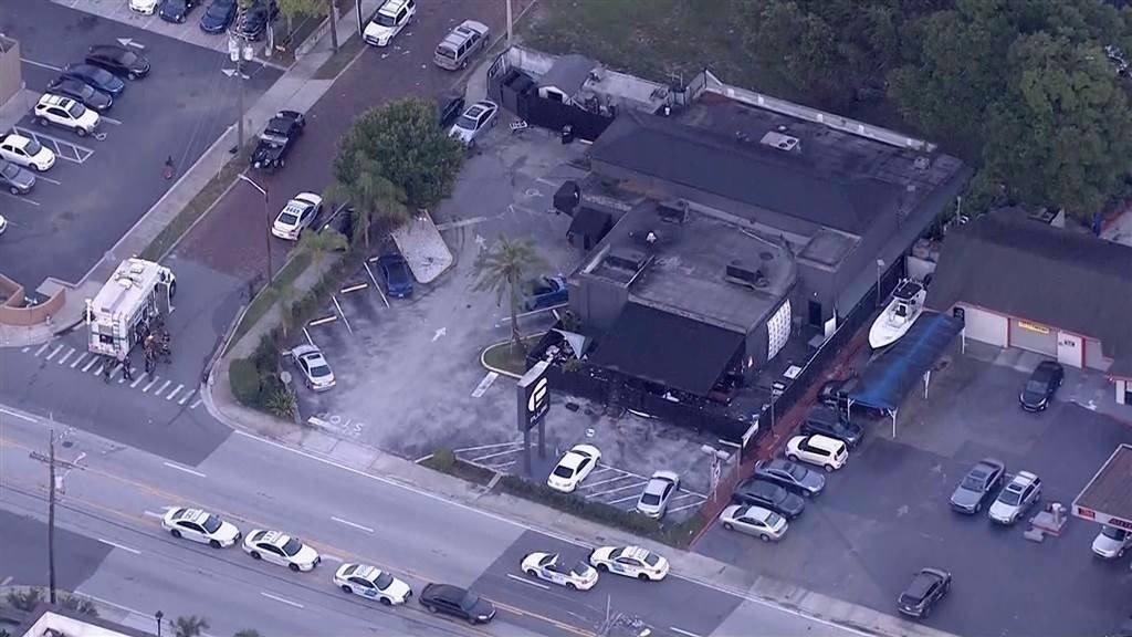 Police vehicles surround the nightclub