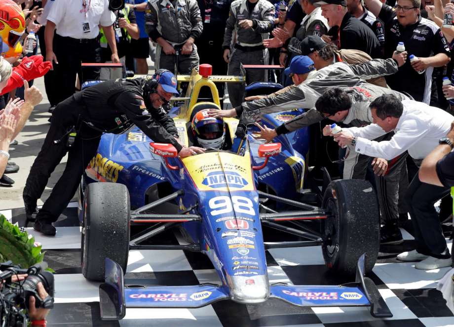 Alexander Rossi is congratulated after winning the 100th running of the Indianapolis 500 auto race as he pulls into victory lane at Indianapolis Motor Speedway in Indianapolis Sunday