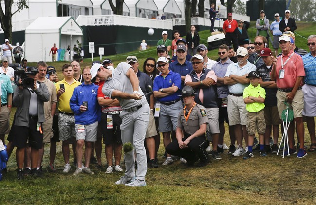 Rory McIlroy of Northern Ireland hits from rough on the 18th hole during the rain delayed first round of the U.S. Open golf championship at Oakmont Country Club on Friday