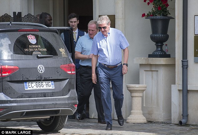 Roy Hodgson watching the Iceland and Portugal games on TV at England’s base in Chantilly