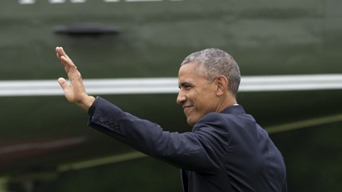 US President Barack Obama waves as he walks to Marine One prior to departure from the South Lawn of the White House in Washington DC