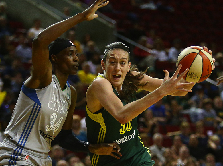 Seattle’s Breanna Stewart drives the ball to the net as she is defended by Minnesota’s Sylvia Fowles