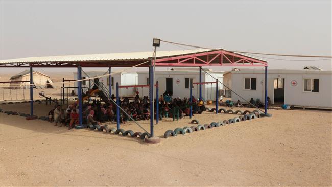 10 2015 shows Syrian refugees sitting at Jordan’s Rukban makeshift refugee camp on the border with Syria