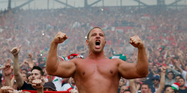 The Hungary team's fans celebrate at the end of the Euro 2016 Group F soccer match between Iceland and Hungary at the Velodrome stadium in Marseille France