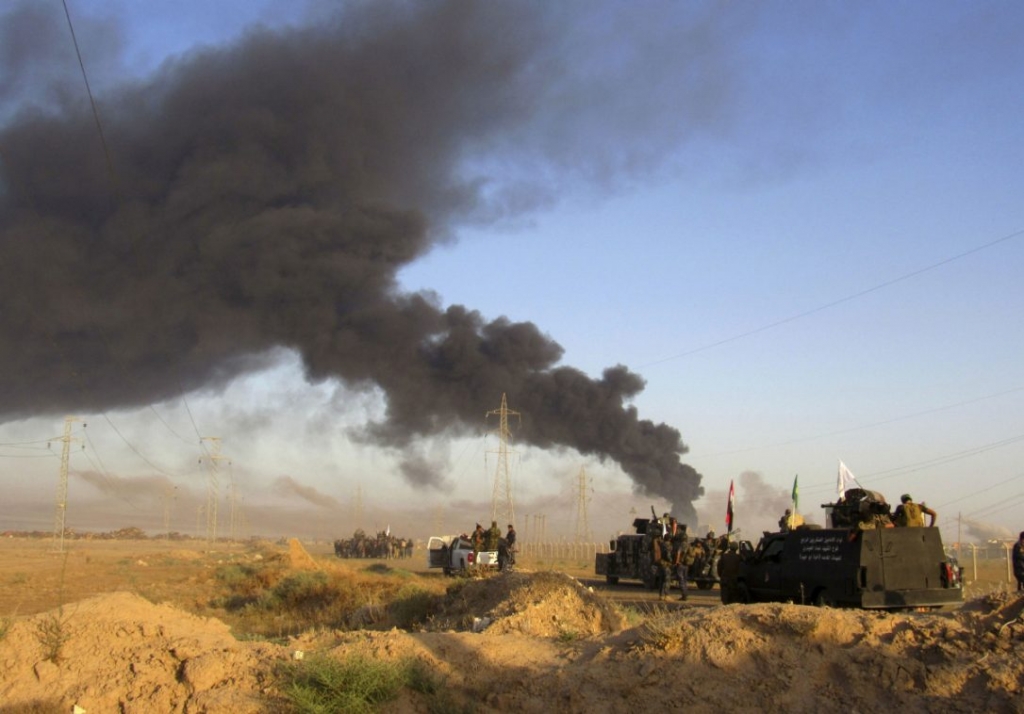 Smoke rises from Islamic State group positions after an airstrike by U.S.-led coalition warplanes in Fallujah 65 kilometers west of Baghdad Iraq Monday