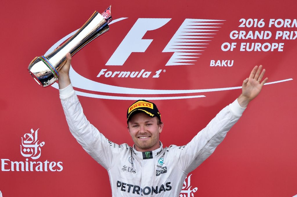 Nico Rosberg celebrates with the trophy on the podium after winning