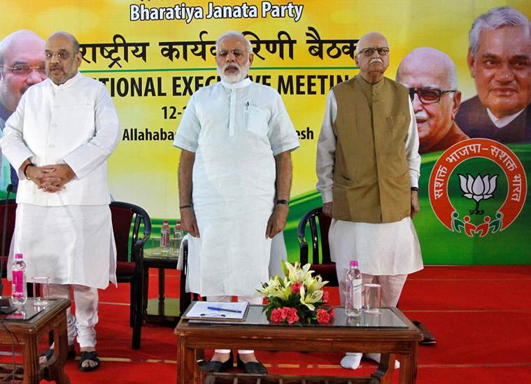 Amit Shah president of India's ruling Bharatiya Janata Party, Prime Minister Narendra Modi and L.K. Advani a leader of BJP sing a patriotic song during the party's national executive meeting in Allahabad India