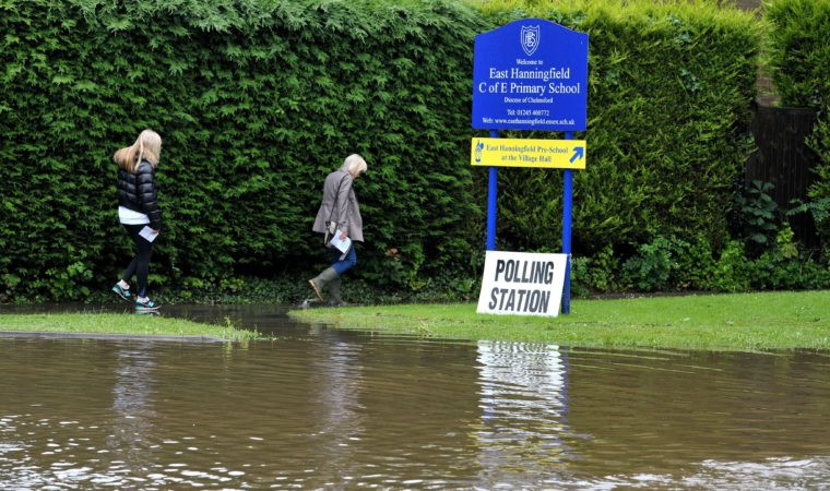 Voters in the EU referendum making their way through floodwater outside a polling station in East Hanningfield Essex