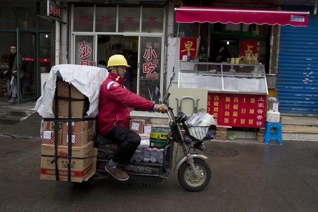 Yihaodian delivery man leaves for his rounds in Shanghai. Wal Mart said Monday