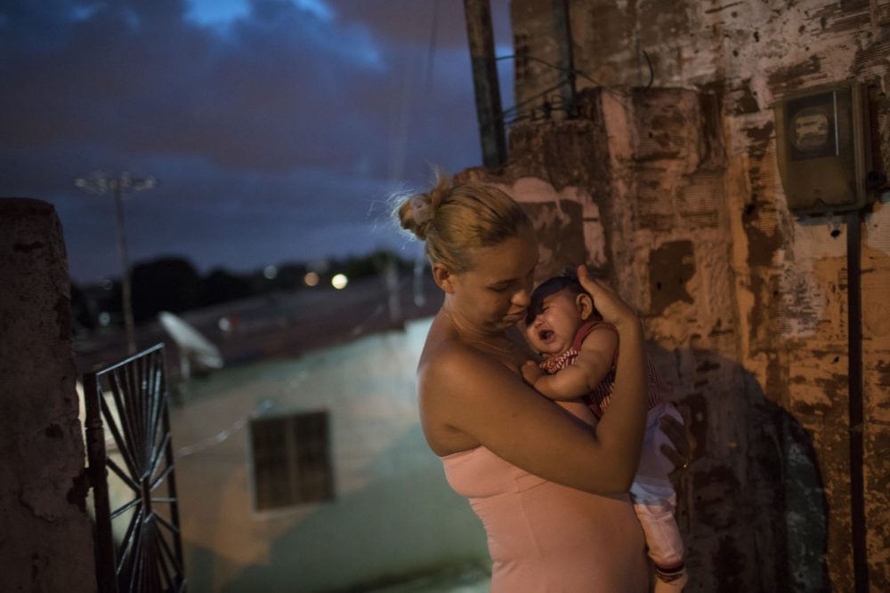 Gleyse Kelly da Silva 27 holds her daughter Maria Giovanna who was born with microcephaly outside their house in Recife Pernambuco state Brazil