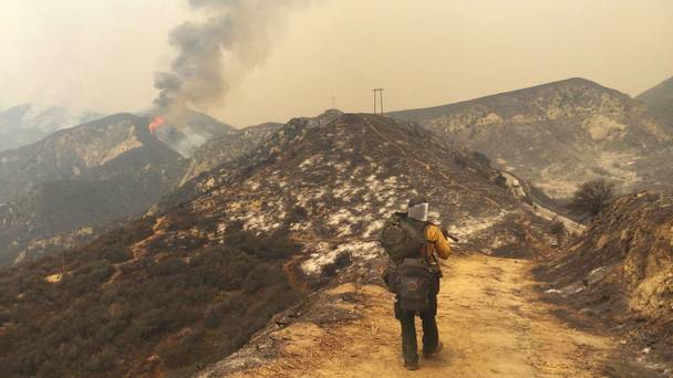 A large plume of smoke from a wildfire rises near Highway 1 burning five miles south of Carmel California