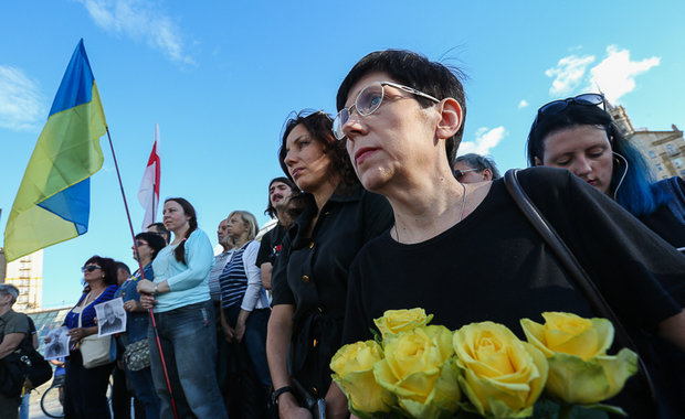 A woman brought flowers as she attends a Pavel Sheremet commemoration rally at Independence square in Kyiv on July 20