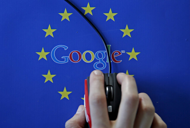 A woman hovers a mouse over the Google and European Union logos in this