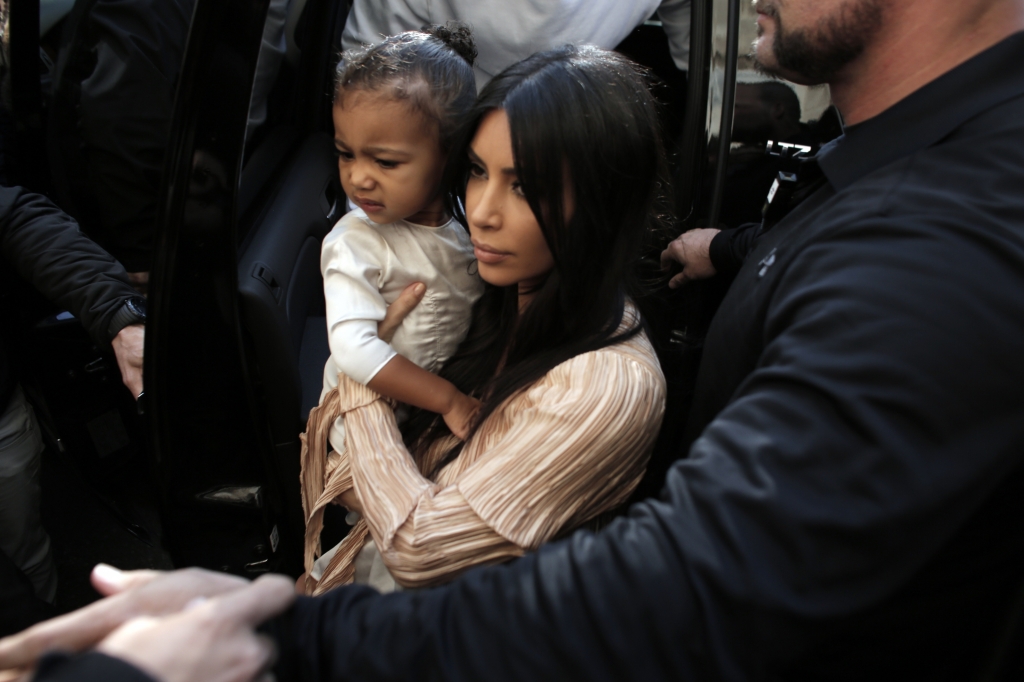 U.S. reality TV star Kim Kardashian carries her daughter North West